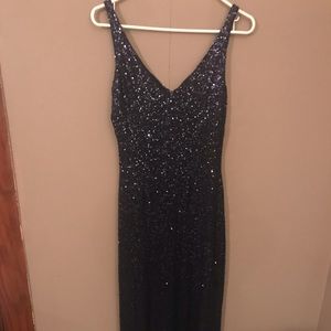 Floor length navy blue sequined dress.